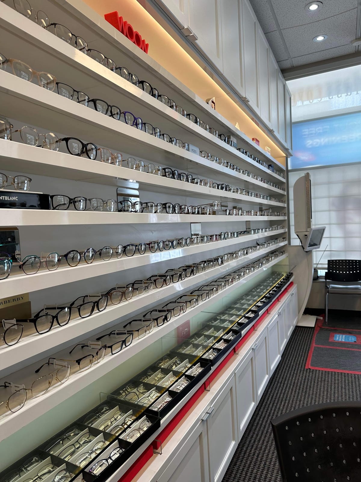 Rows of frames on the lit display shelves of the iSight frames boutique